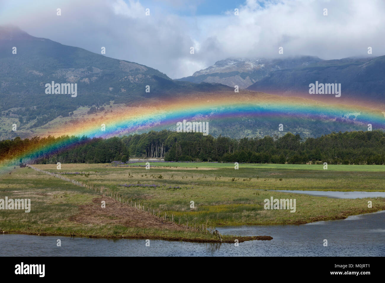 Rainbow at a river in front of the Andes, O higgins, Region de Aysen, Chile Stock Photo