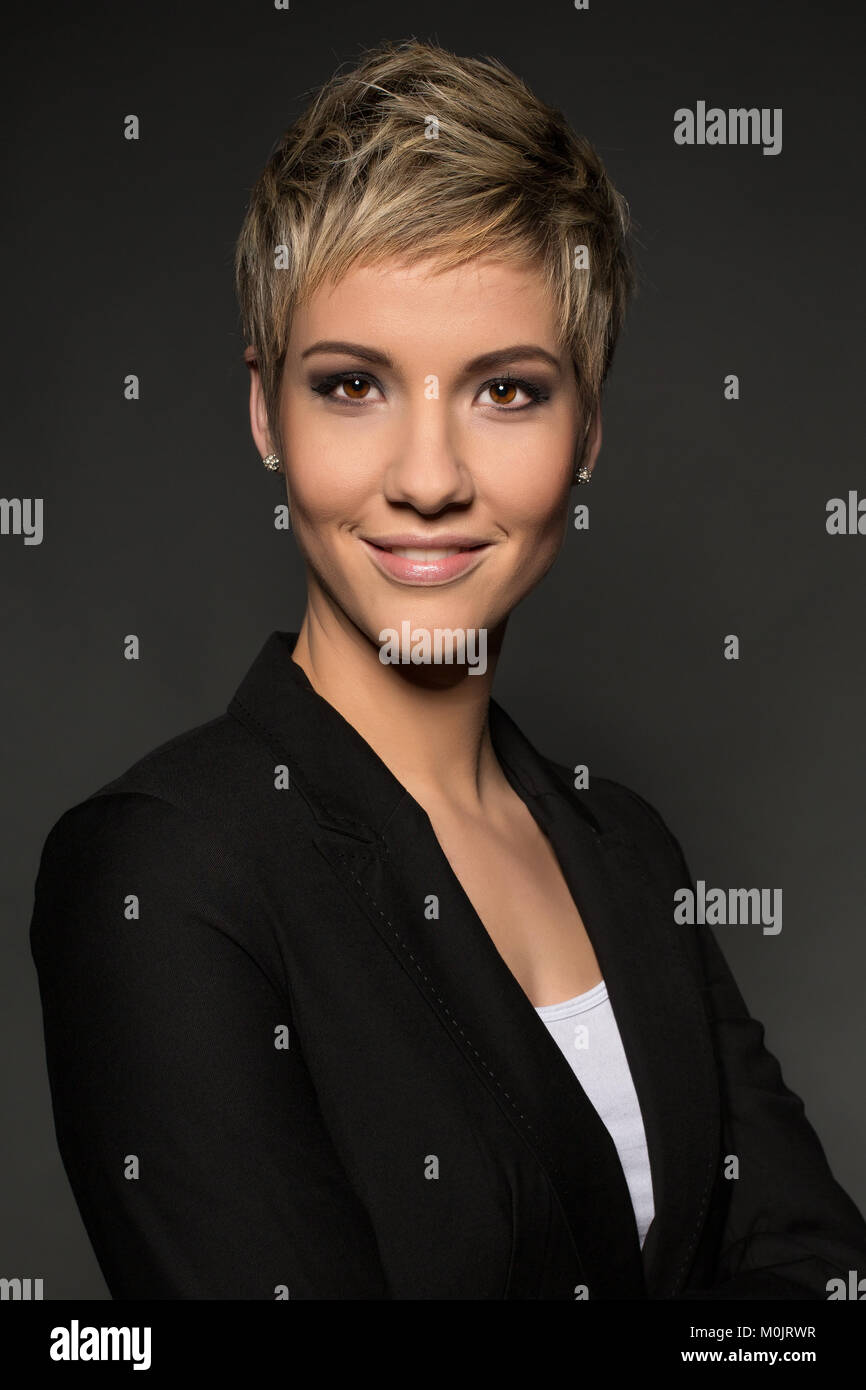 Smiling, short-haired woman, blond, in business look, portrait Stock Photo