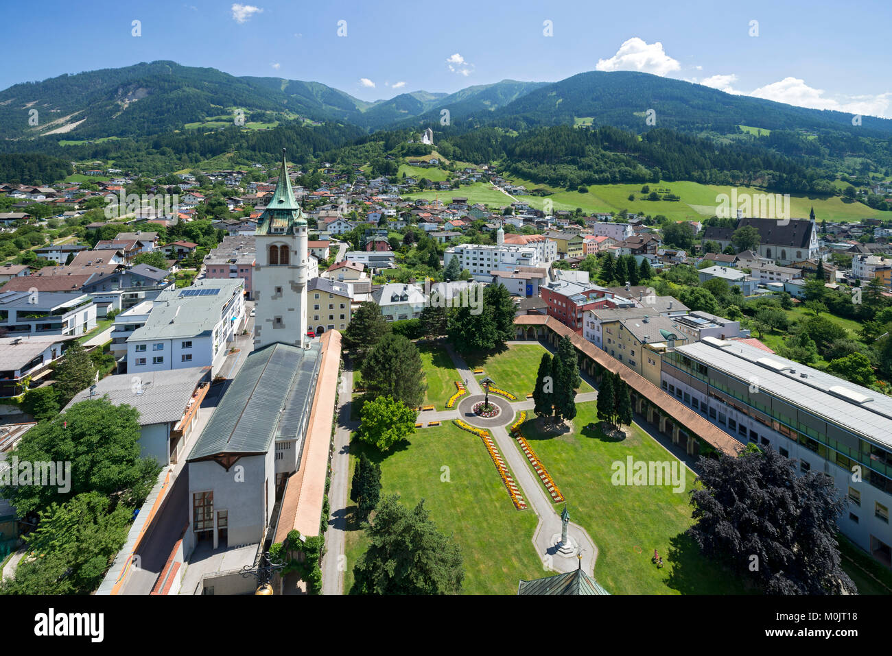 Stadtpark Schwaz with the new bell tower of the parish church Maria Himmelfahrt, in the back the castle Freundsberg and the Stock Photo