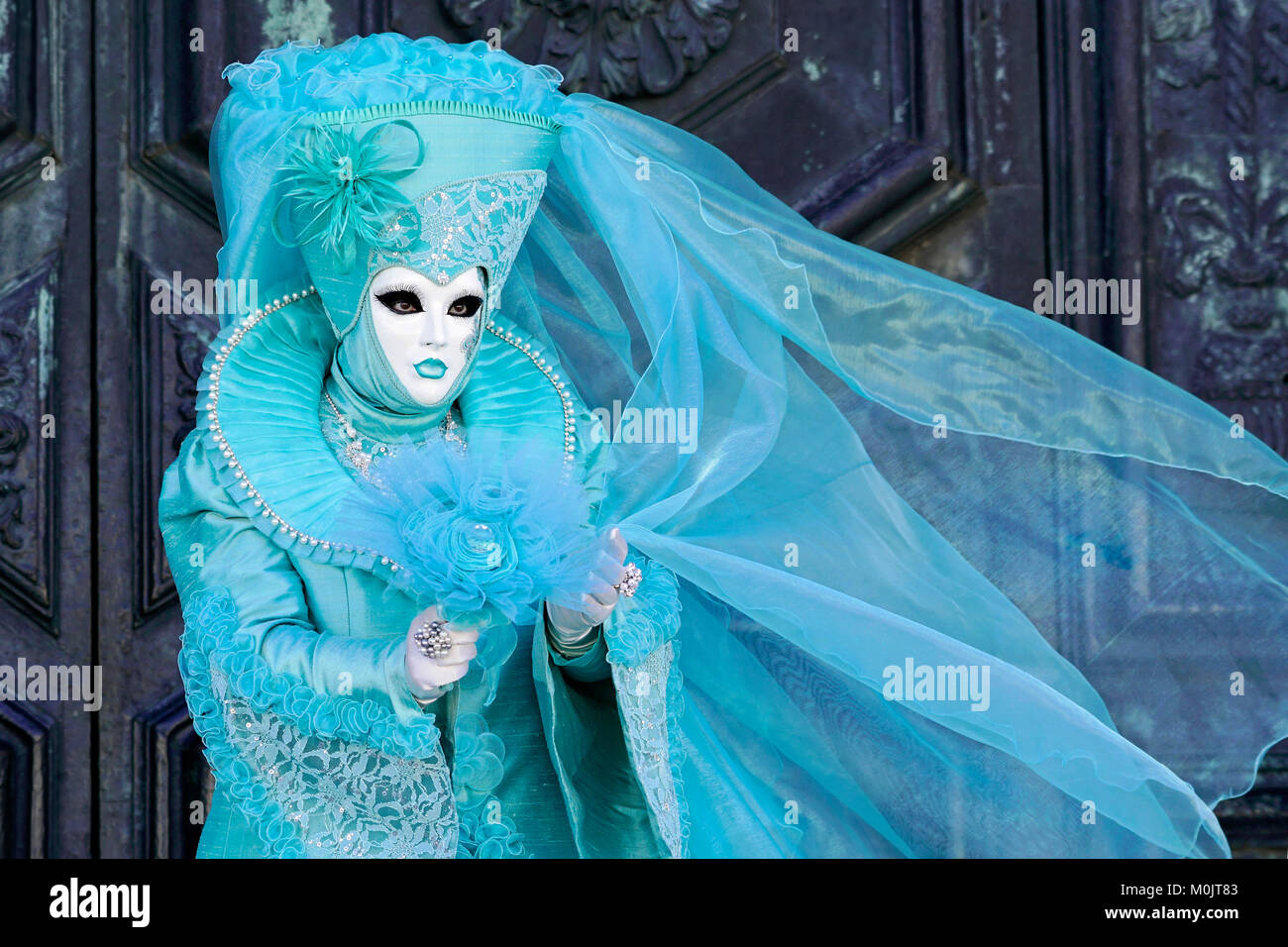 Woman in turquoise carnival costume, Carnival in Venice, Italy Stock Photo