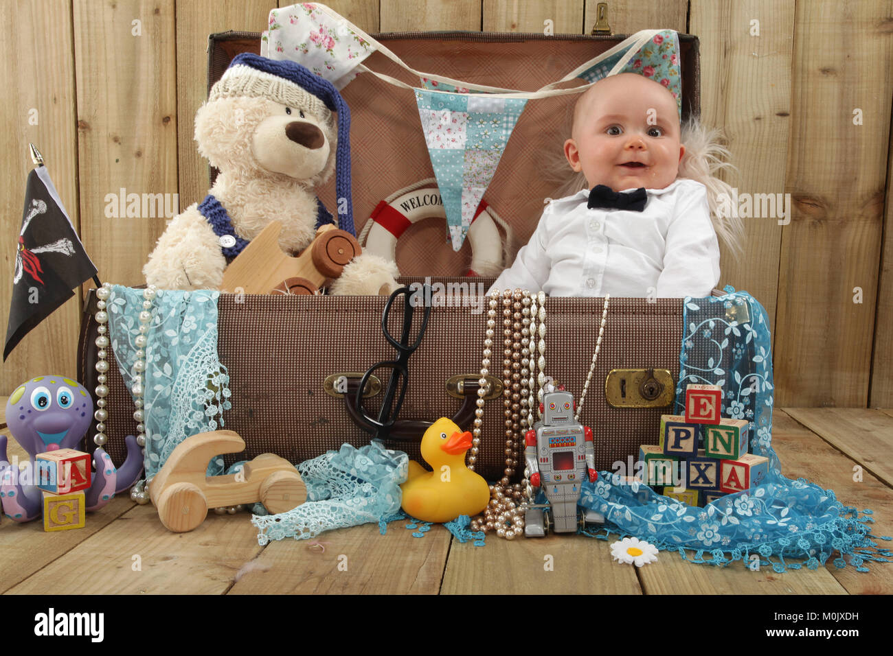 boy playing in toy box, vintage suitcase Stock Photo Alamy