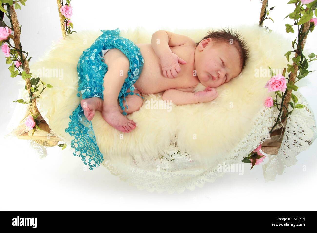 newborn baby boy sleeping on swing bed Stock Photo