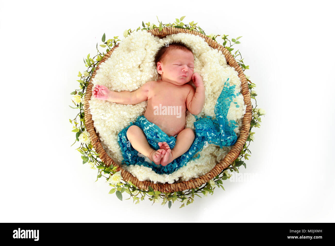 newborn baby boy sleeping in basket Stock Photo