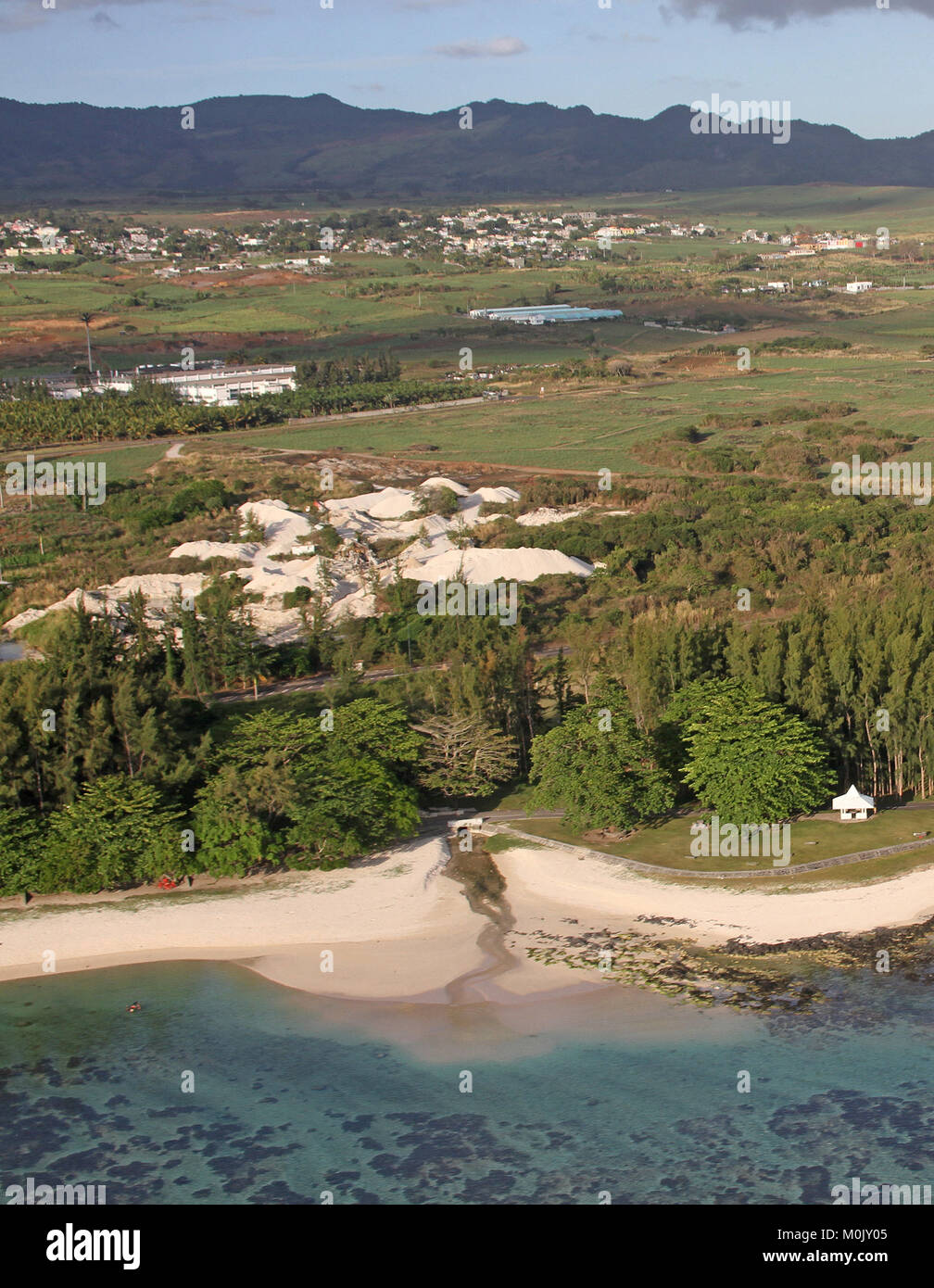 Water pipeline leaking into beach from forest, view from helicopter, near Le Morne Brabant, Riviere Noire District, The Republic of Mauritius. Stock Photo