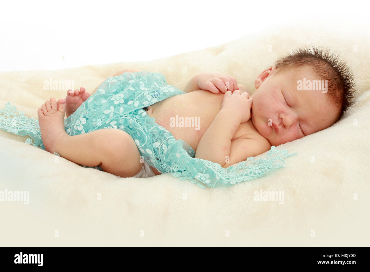 newborn baby boy sleeping on rug Stock Photo