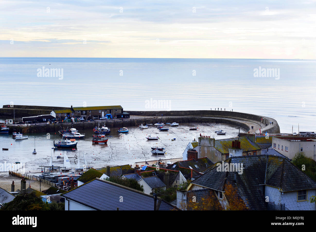 Lyme Regis Bay with a view of the Cob and small boats in the harbour. Stock Photo