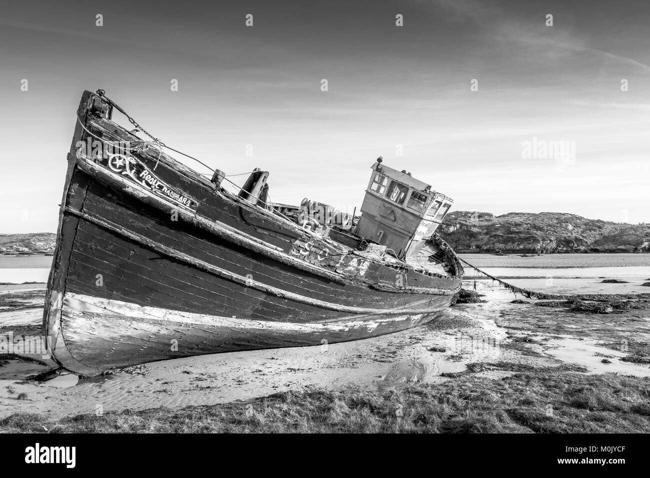 This is a photo of a wrecked fishing boat on Cruit Island on the Donegal coast in Ireland Stock Photo