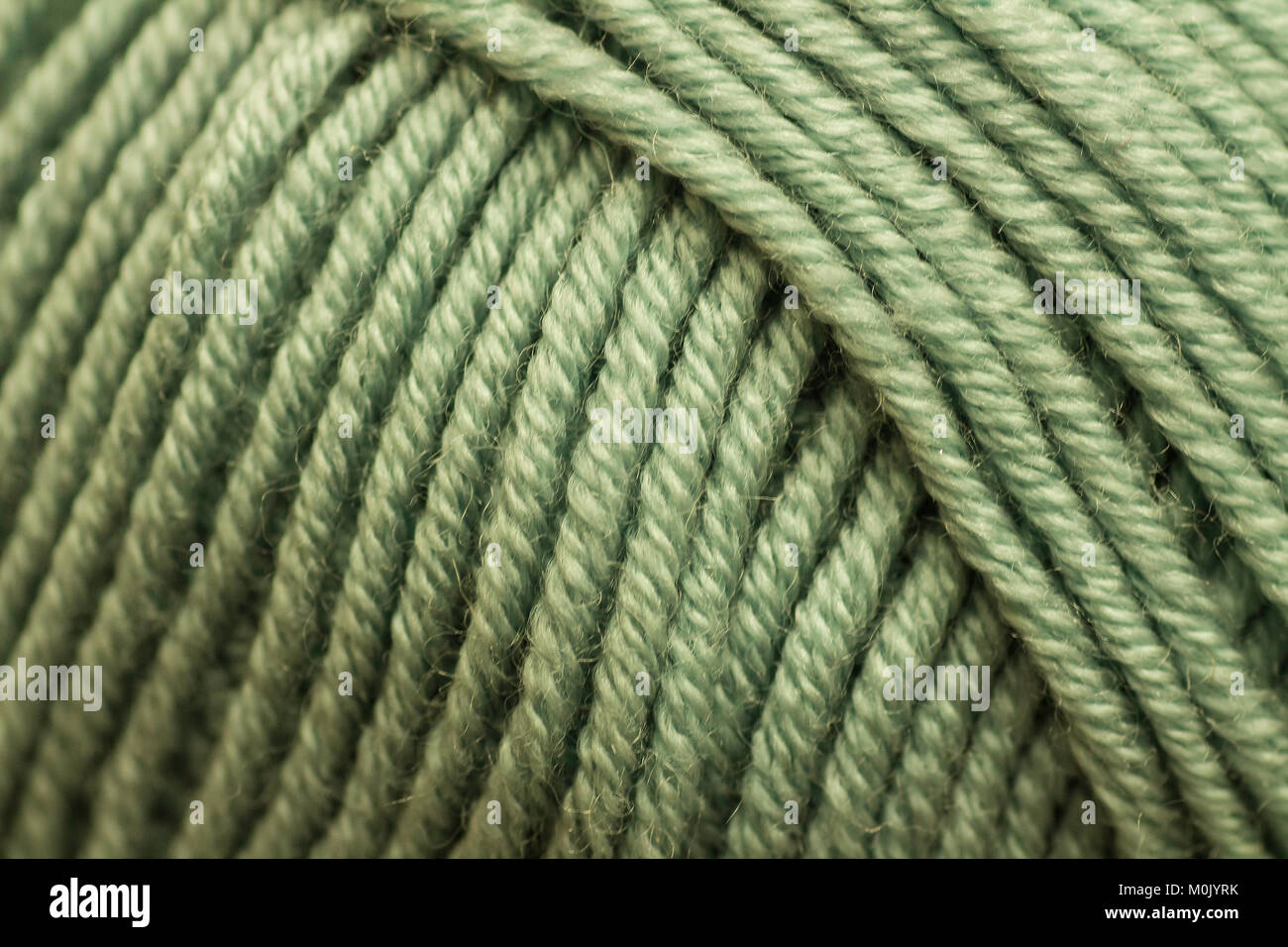 Macro photograph of a green ball of wool Stock Photo