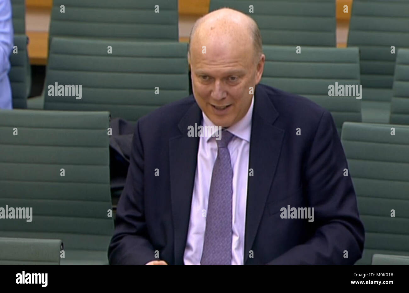 Transport Secretary Chris Grayling answering questions in front of the Transport Select Committee in the House of Commons, London on the controversial decision not to go ahead with three rail electrification schemes. Stock Photo