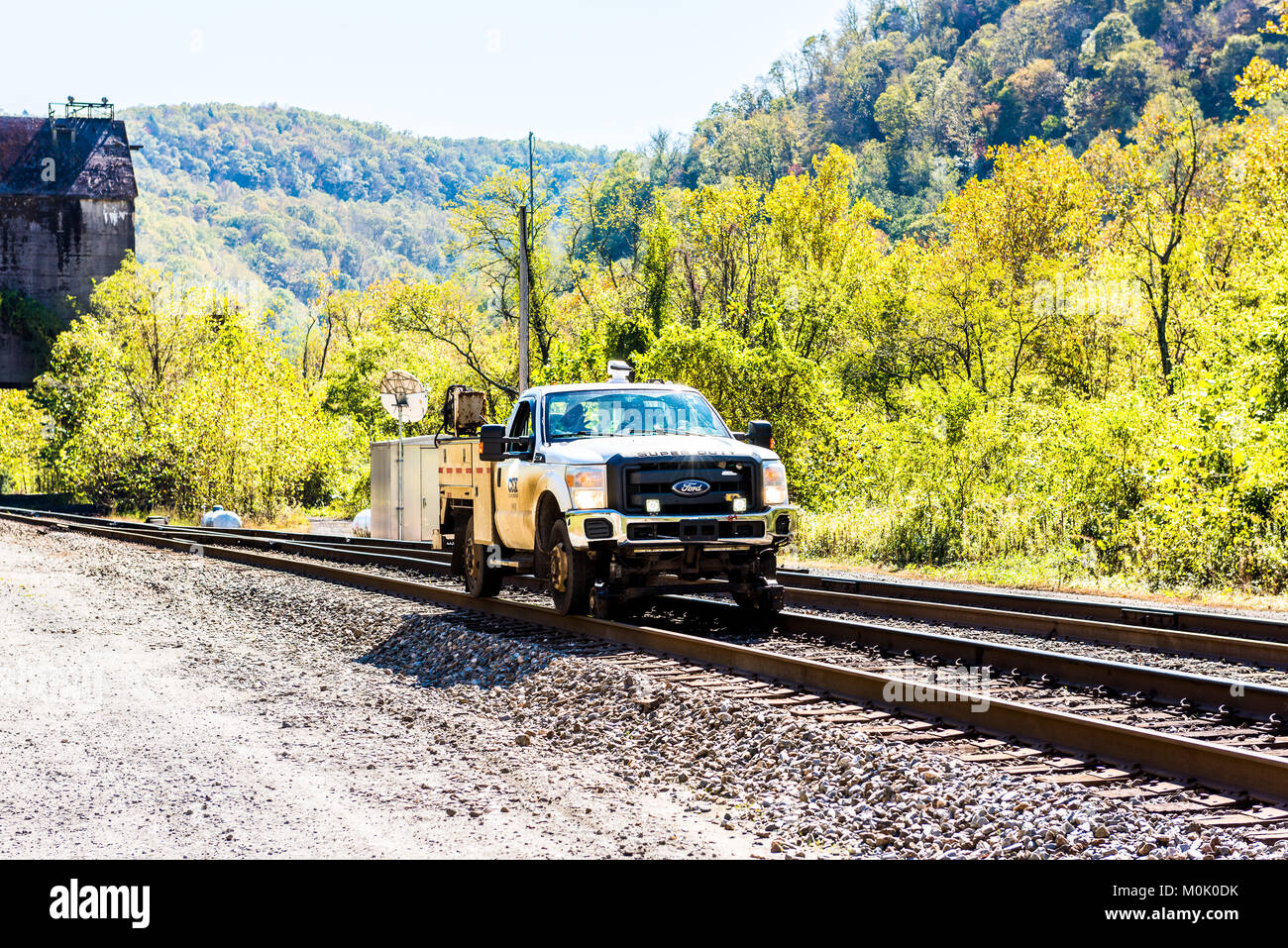 Thurmond, USA - October 19, 2017: Railroad rail with CSX car truck riding in West Virginia ghost town village Stock Photo
