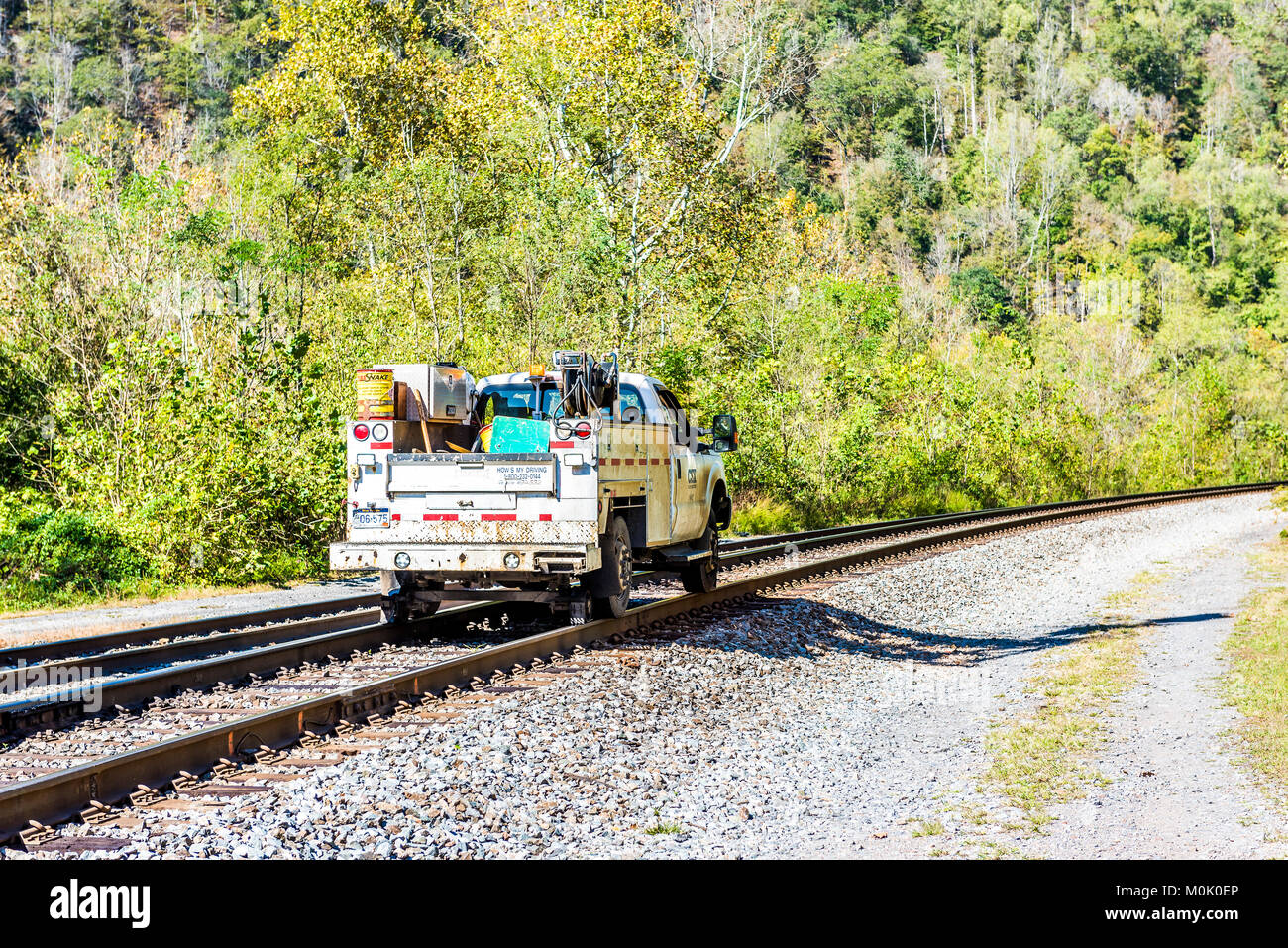 Thurmond, USA - October 19, 2017: Railroad rail with CSX car truck riding in West Virginia ghost town village Stock Photo