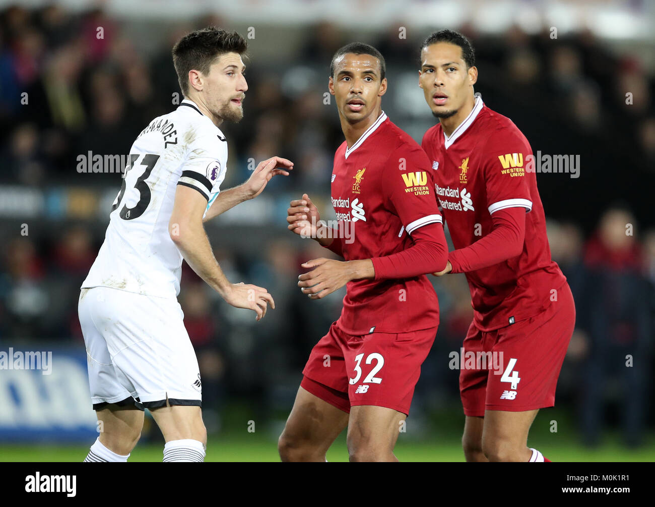 Liverpool's Joel Matip (centre) and Virgil van Dijk prepare to attack a corner, watched by Swansea City's Federico Fernandez during the Premier League match at the Liberty Stadium, Swansea. Stock Photo