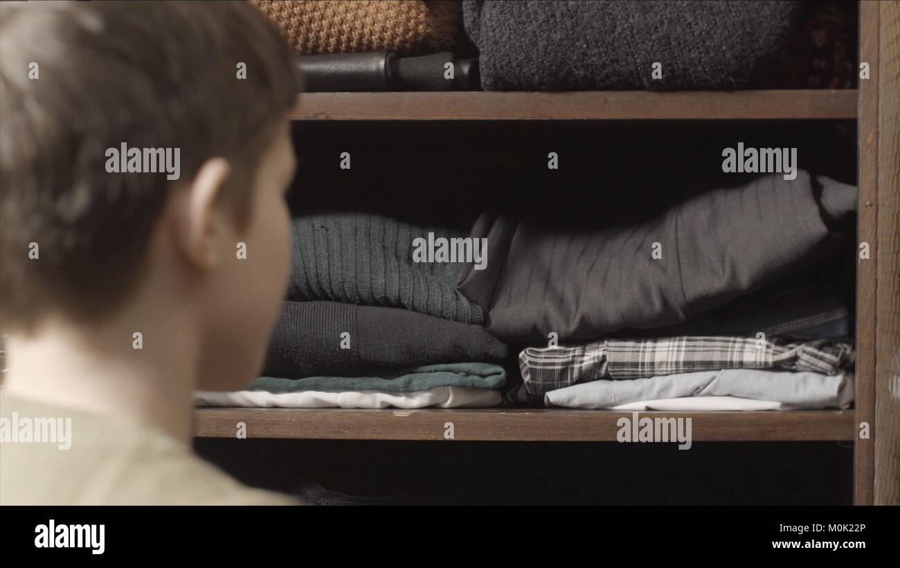 The Child Puts His Clothes On The Boy Pulls The T Shirt Out Of