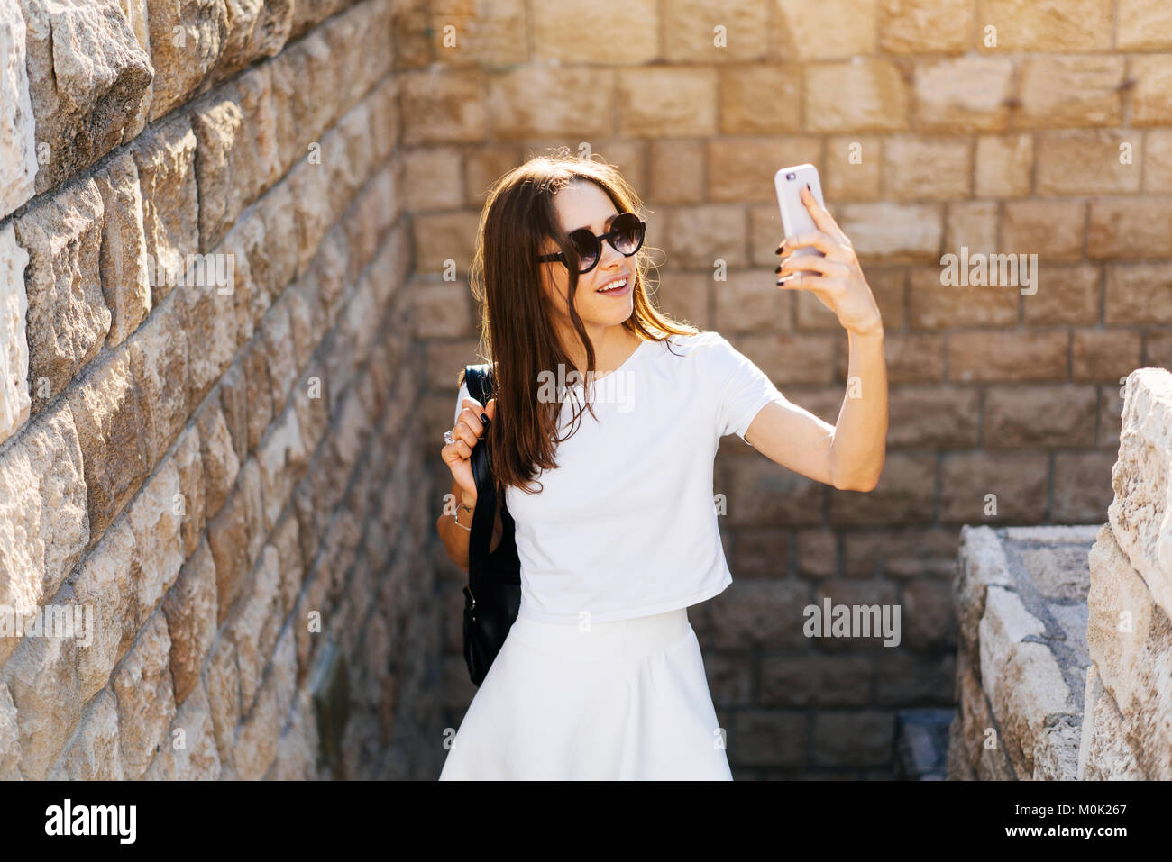 Happy young woman taking selfie Stock Photo - Alamy