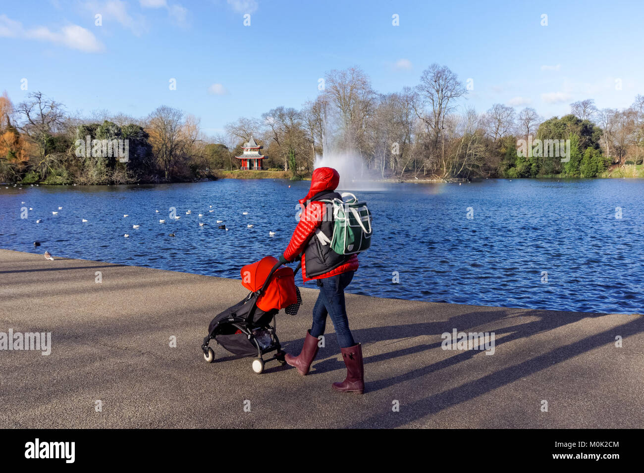 Person walk with a child in Victoria Park during winter, London England United Kingdom UK Stock Photo