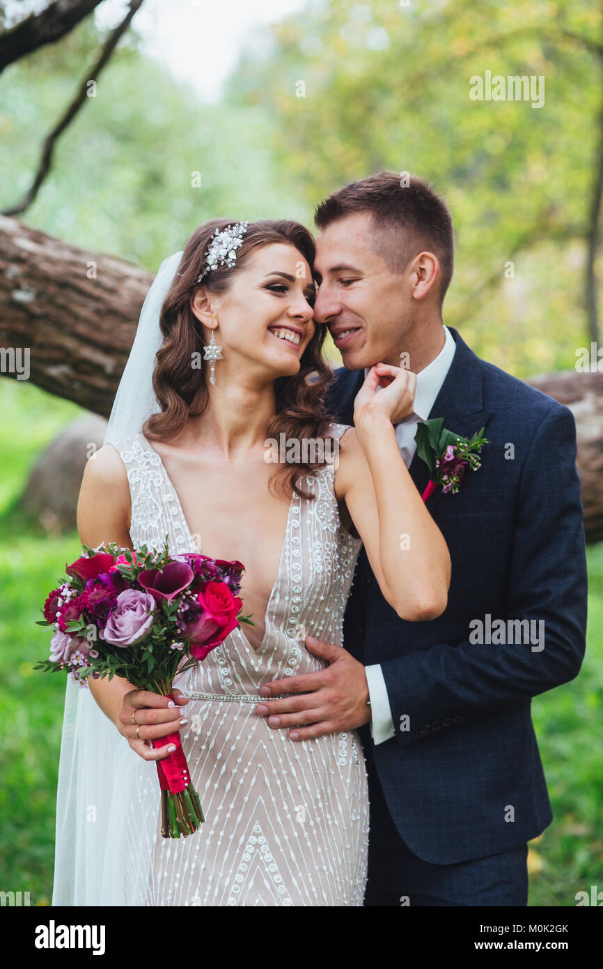 Bride and groom embracing in the park. Wedding Stock Photo - Alamy