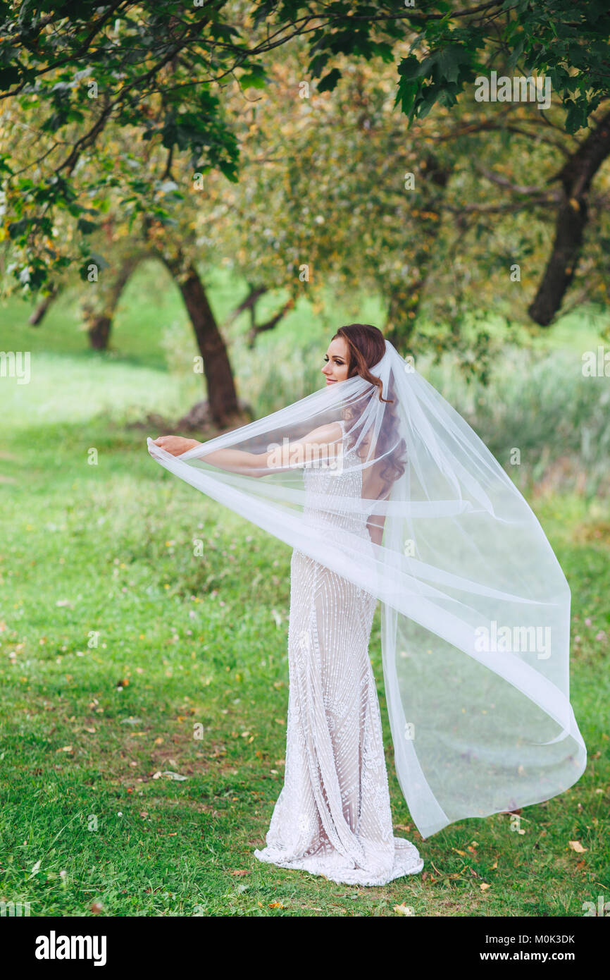 Young beautiful woman with veil park Stock Photo - Alamy