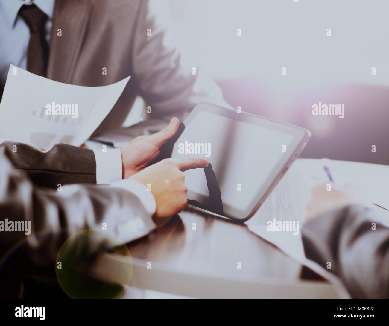 Businessman holding digital tablet at meeting Stock Photo - Alamy