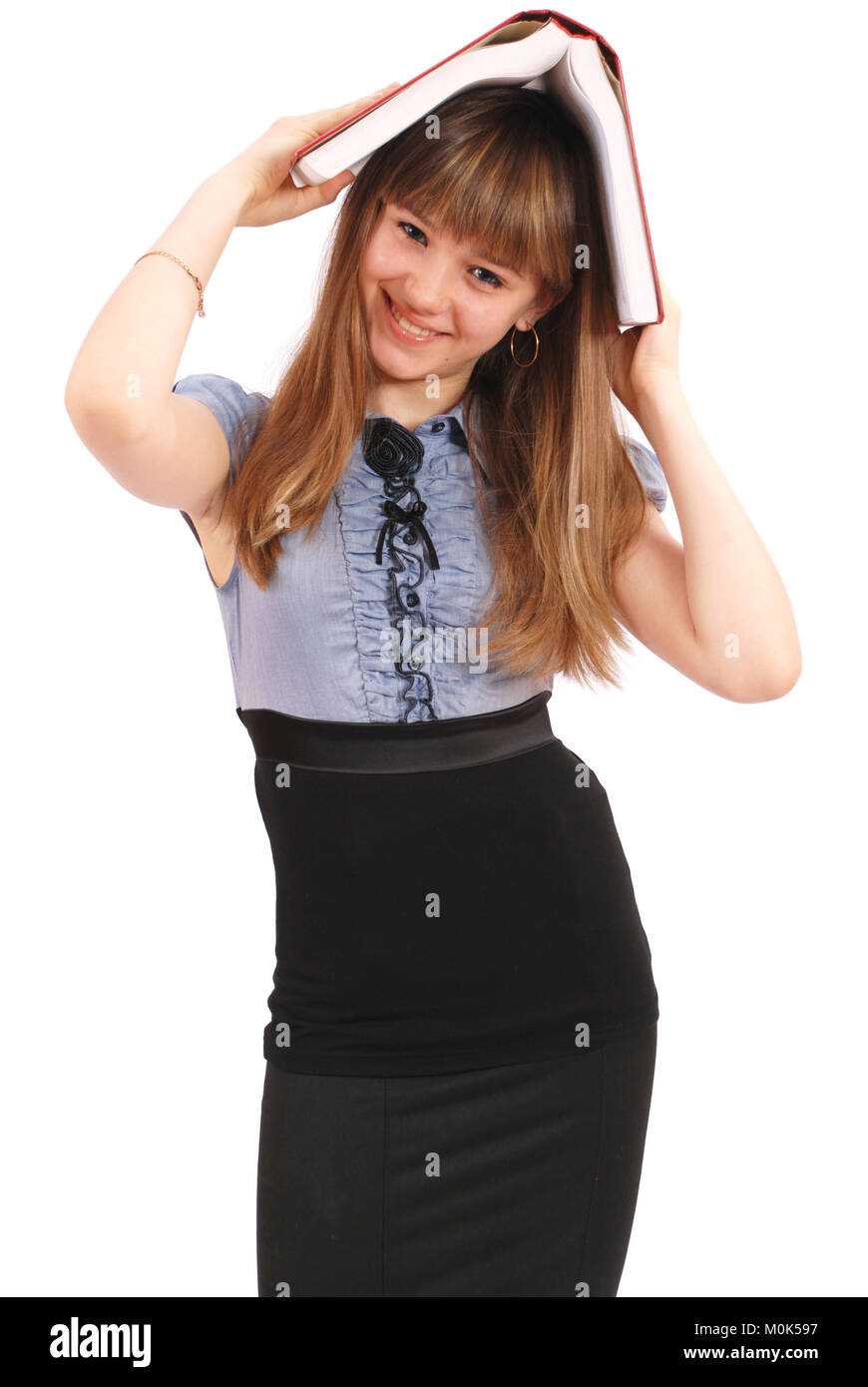 Girl holds the book on a head. On white background Stock Photo - Alamy