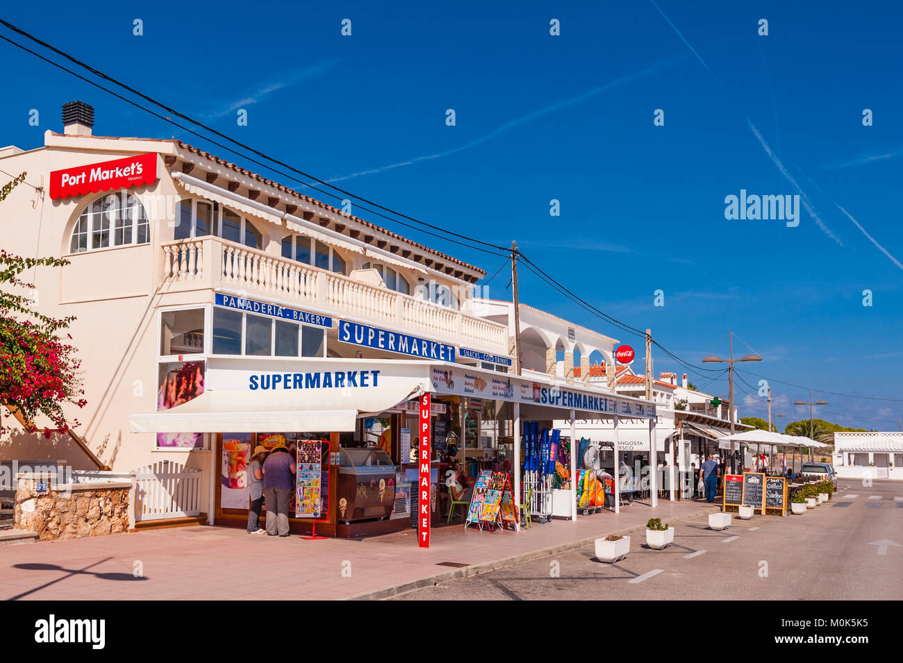 The local supermarket and stores at Punta Prima , Menorca , Balearic Islands , Spain Stock Photo
