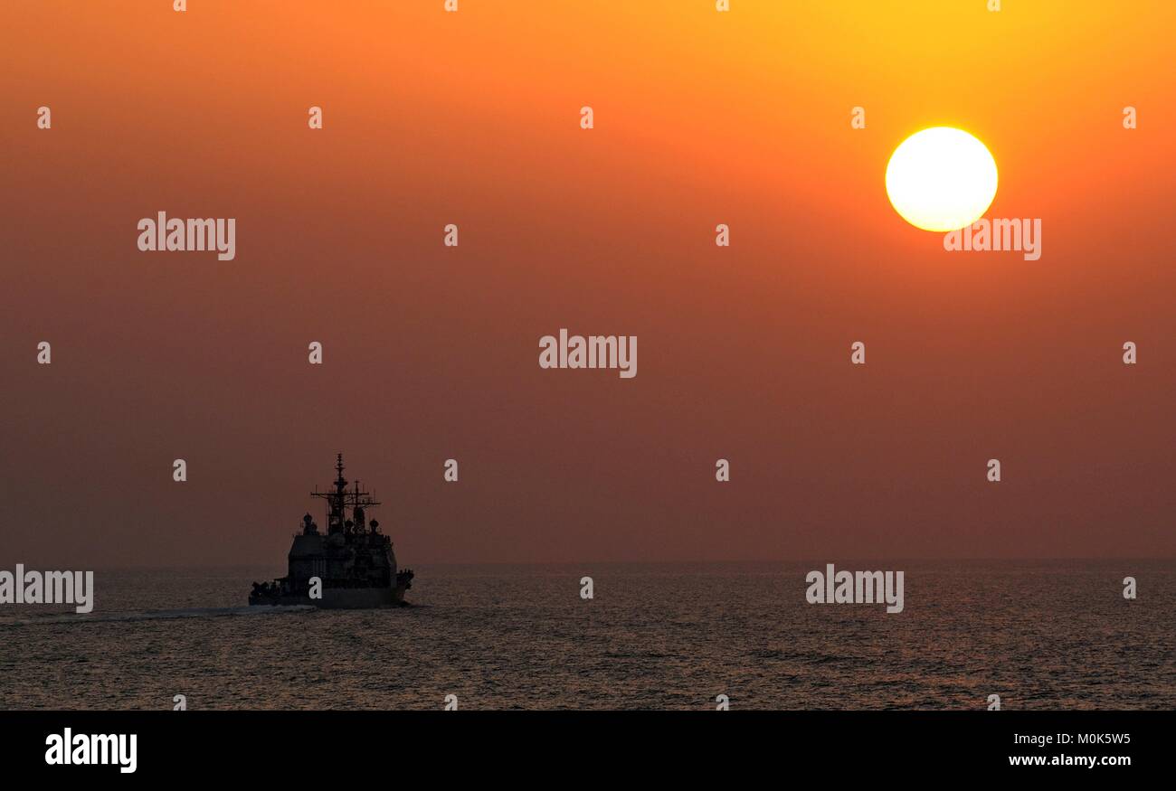 The U.S. Navy Ticonderoga-class guided-missile cruiser USS Cape St. George steams underway at sunset November 3, 2010 in the Arabian Gulf. Stock Photo