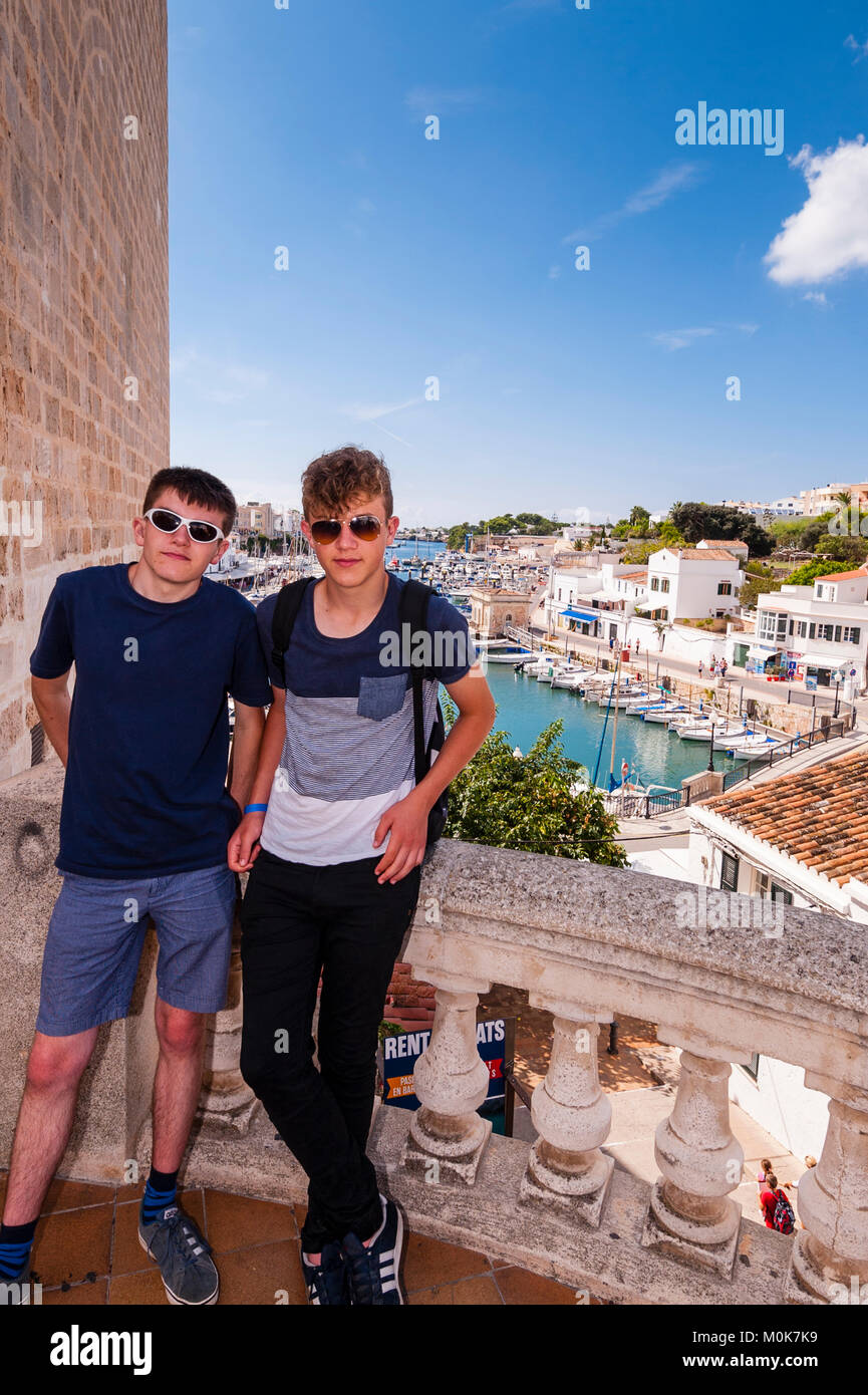 Two teenage boys brothers in the Port in Ciutadella de Menorca , Menorca , Balearic Islands , Spain Stock Photo