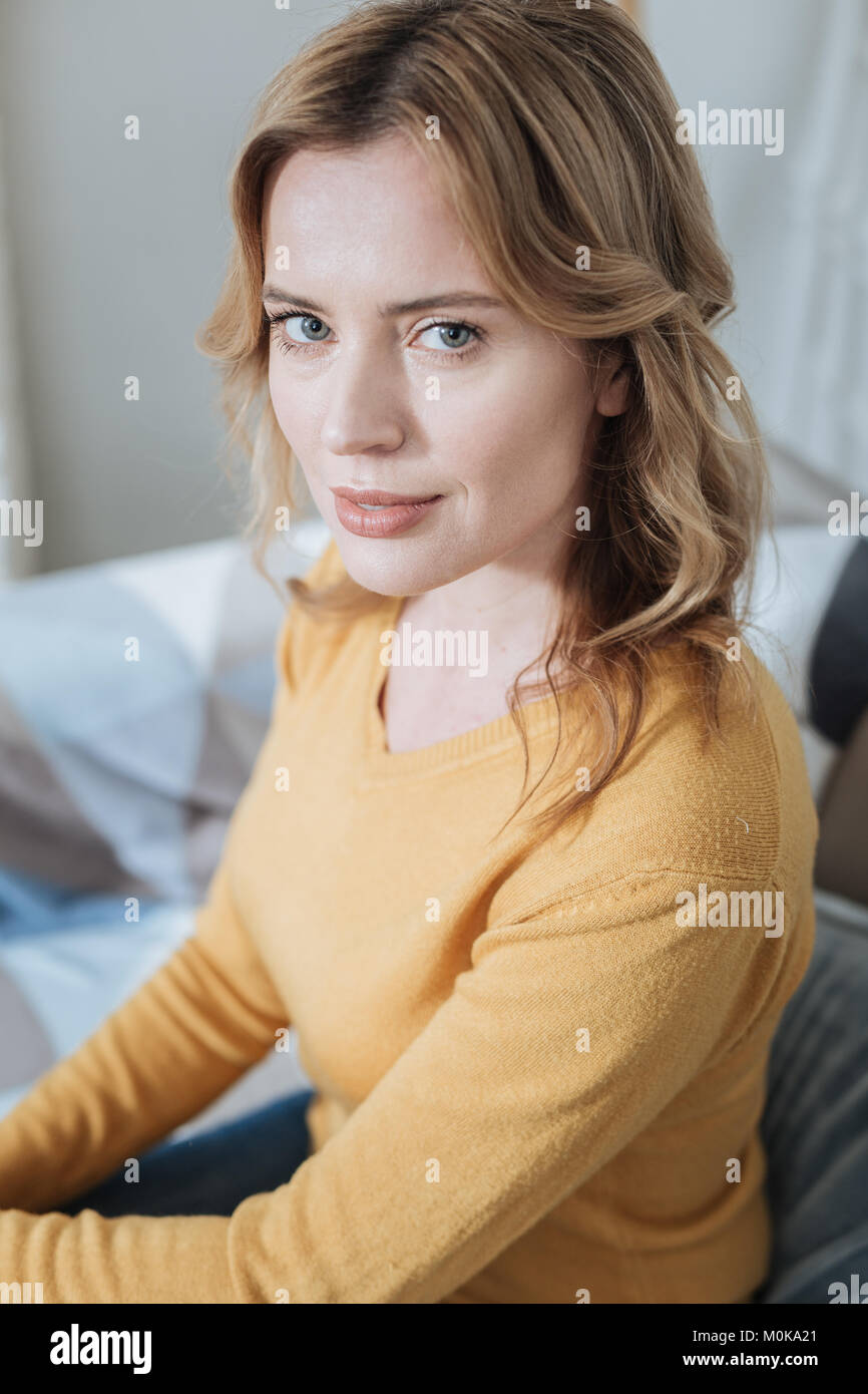 Smiling young woman sitting and relaxing Stock Photo