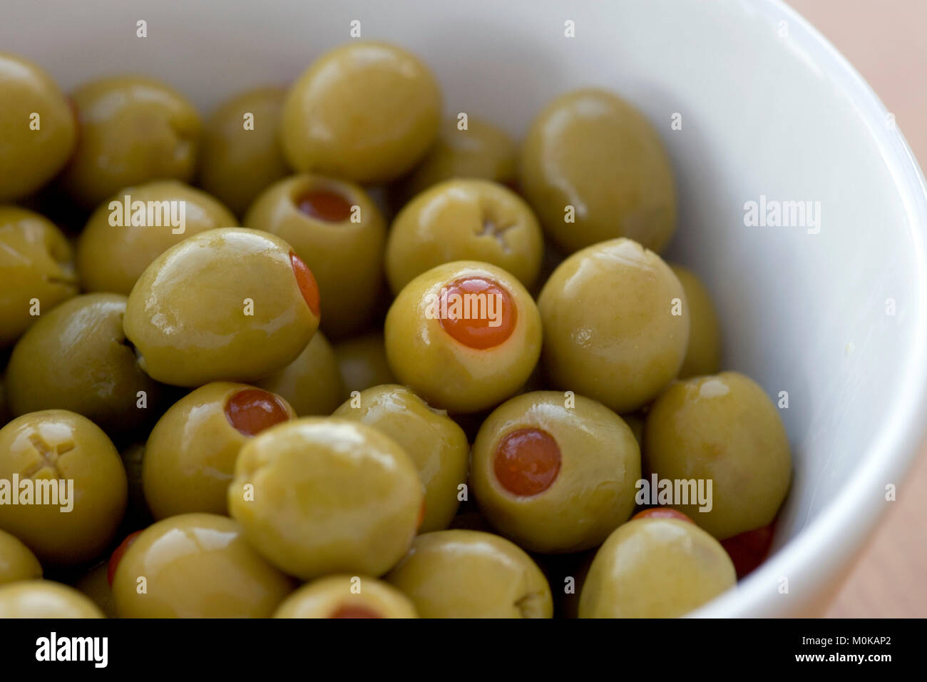 Pimento stuffed green olives in a white bowl Stock Photo Alamy