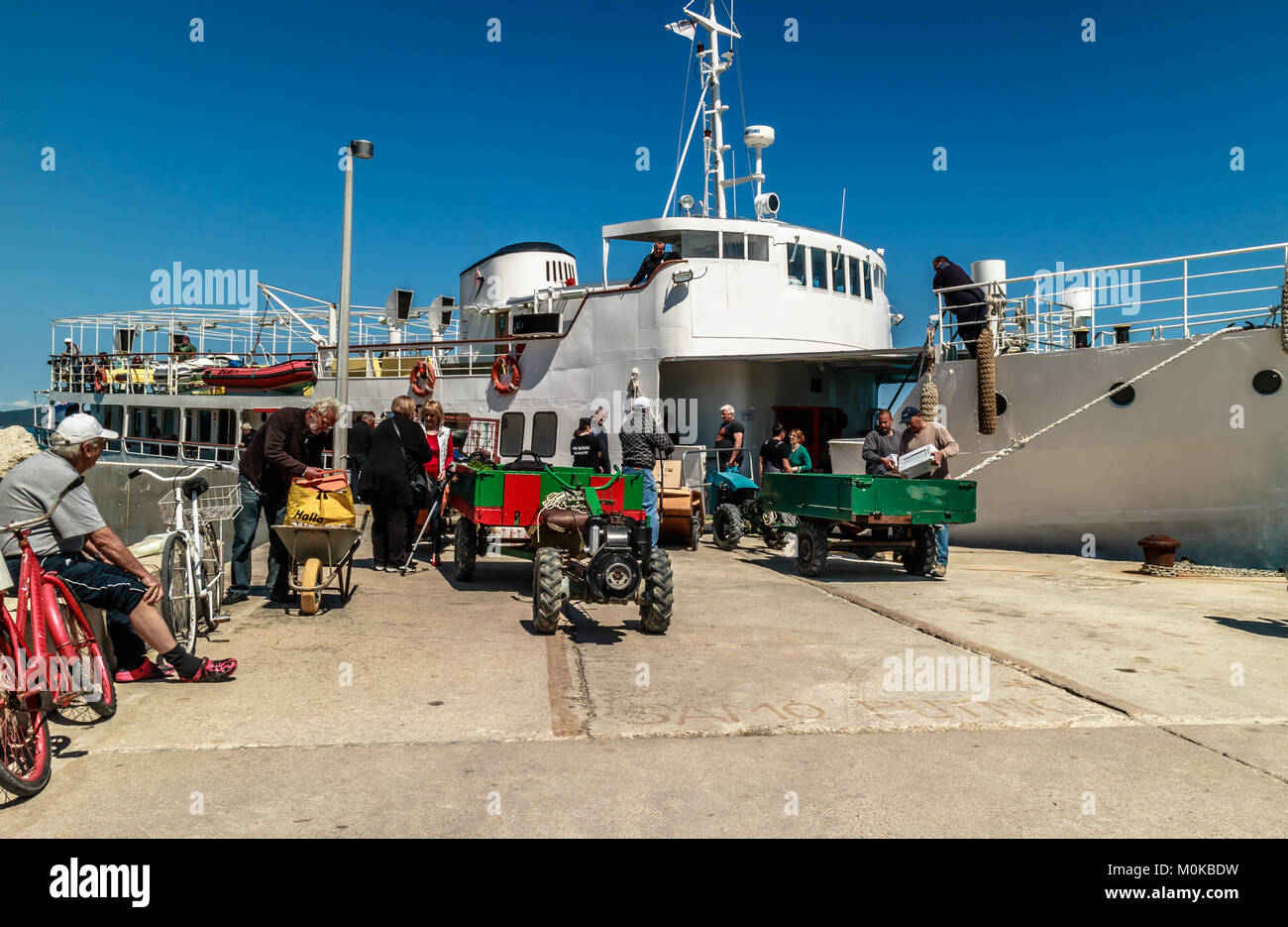 Islanders loading shopping off ferry at Susak, having travelled from larger island of Losinj. Susak, Croatia. May 2017. Stock Photo