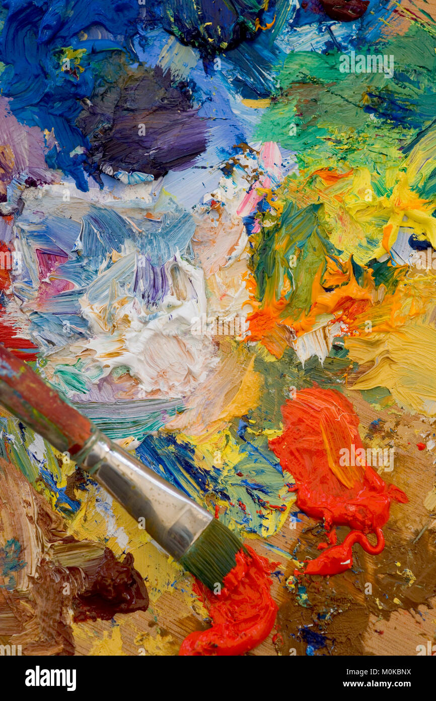 Artists oil paints and brush multi coloured close up semi abstract