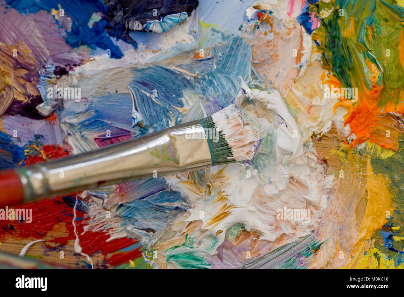 Artists oil paints and brush multi coloured close up semi abstract Stock Photo