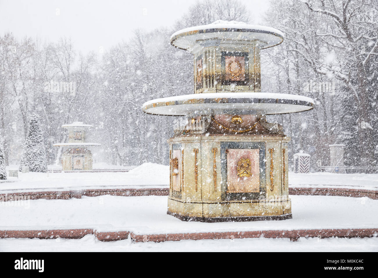 SAINT PETERSBURG, RUSSIA - JANUARY 22, 2018: Peterhof in winter. Roman fountains in the Lower Park of Peterhof in heavy snowfall Stock Photo