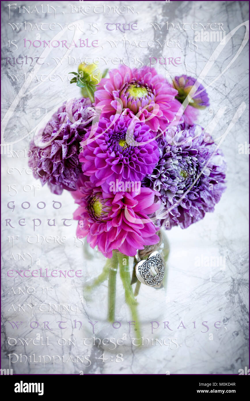 Marbled purple dahlia's arranged in a glass jar with Philippians 4:8 written in the background, and the word 'lovely' written over the flowers Stock Photo
