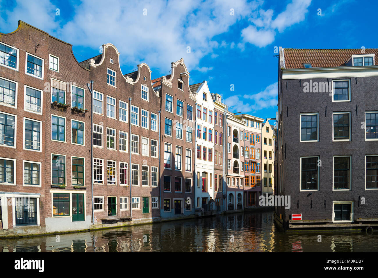 Traditional dutch medieval buildings on the water, Amsterdam. Stock Photo