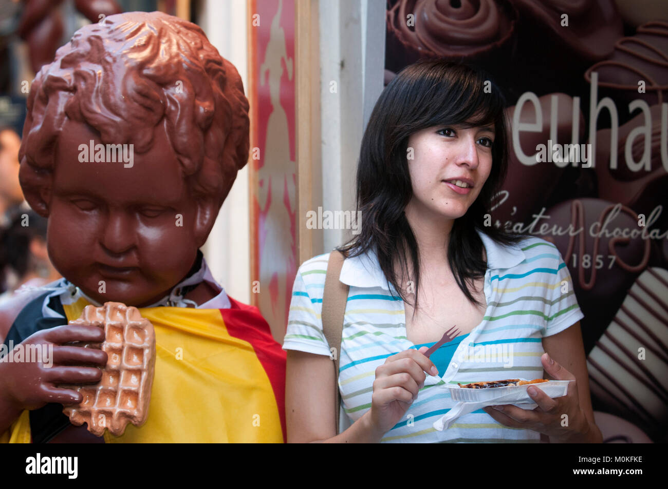 A woman posing next to an gofres or wafles advertisement, Brussels, Belgium. Stock Photo