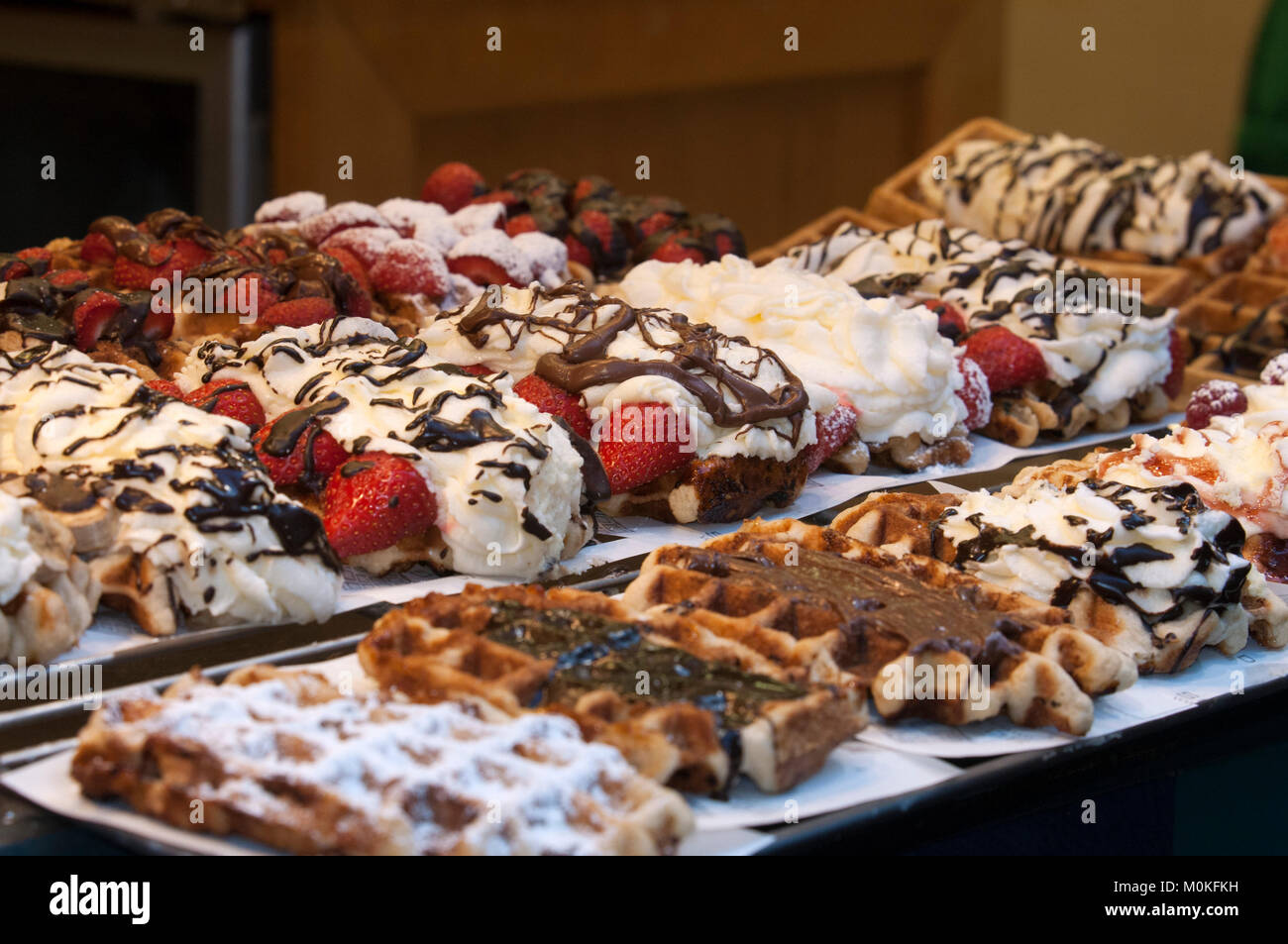 A showcase of a bakery with chocolate and cream wafles advertisement, Brussels, Belgium. Stock Photo