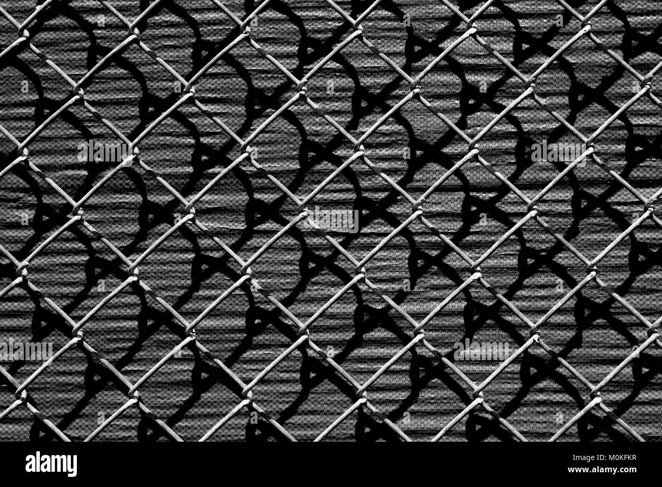 Shadows and Chain Link Fence Stock Photo