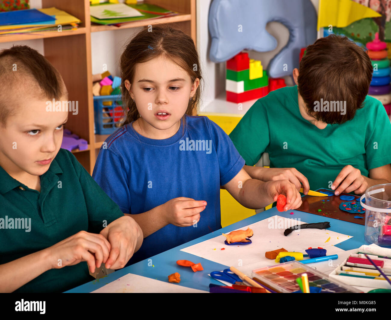 Plasticine modeling clay in children class. Teacher teaches in school ...
