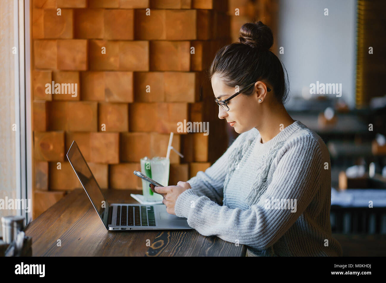 brunetter woman working on her laptop at a restaurant Stock Photo