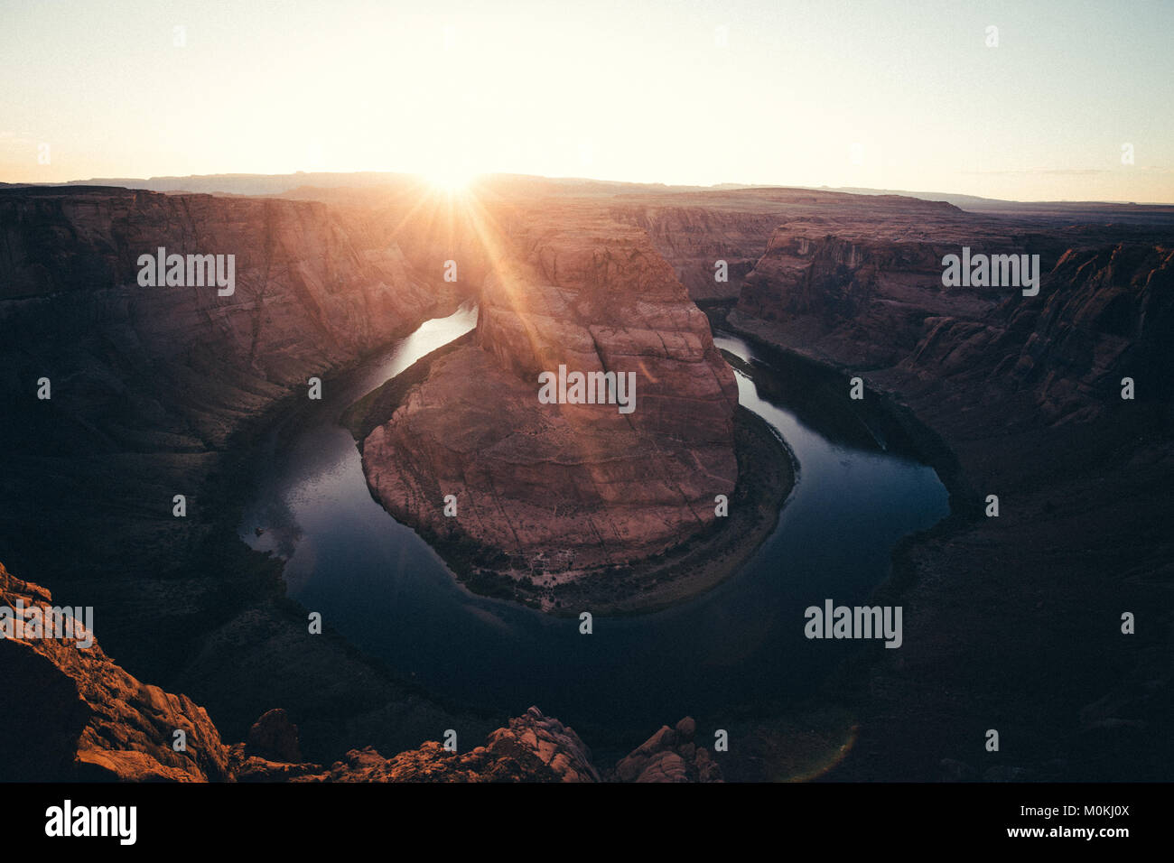 Classic wide-angle view of famous Horseshoe Bend, a horseshoe-shaped meander of the Colorado River located near the town of Page, in beautiful golden  Stock Photo