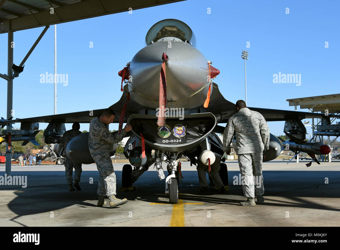 U.S. Airmen assigned to the 20th Fighter Wing visually inspect an F ...
