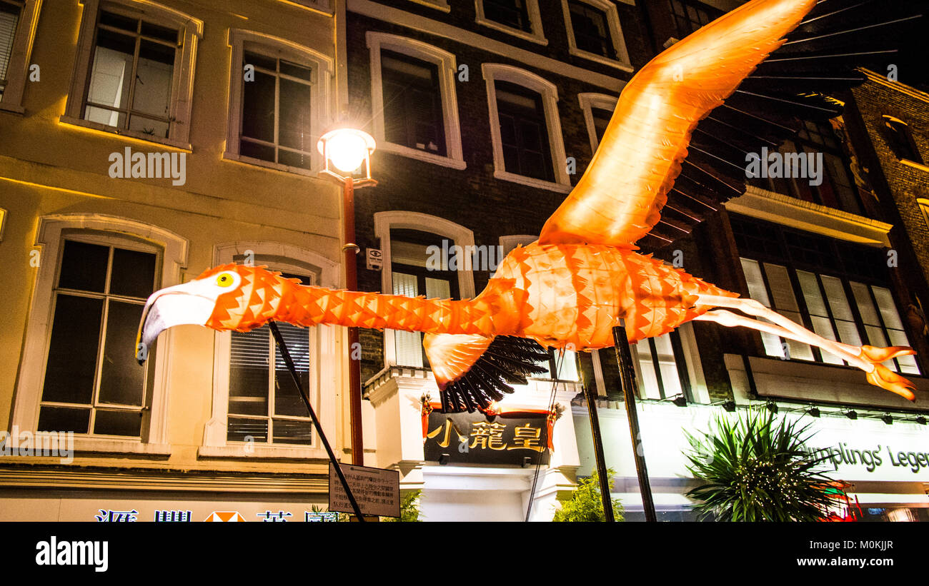 'Flying' Flamingo operated by puppeteers in Chinatown during the 'Lumiere' Light Festival, London. Stock Photo