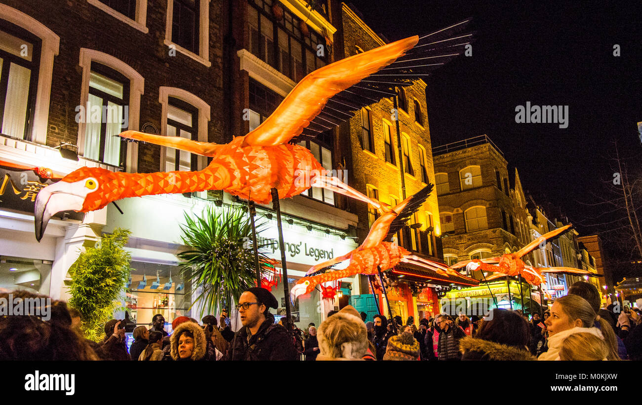 'Flying' Flamingo's operated by puppeteers in Chinatown during the 'Lumiere' Light Festival, London. Stock Photo