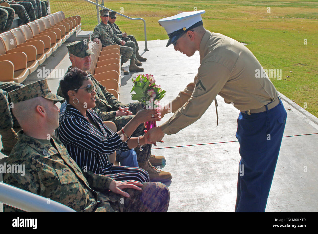 A Marine delivers flowers to the wife of, Sgt. Maj. Travis L. Debarr ...