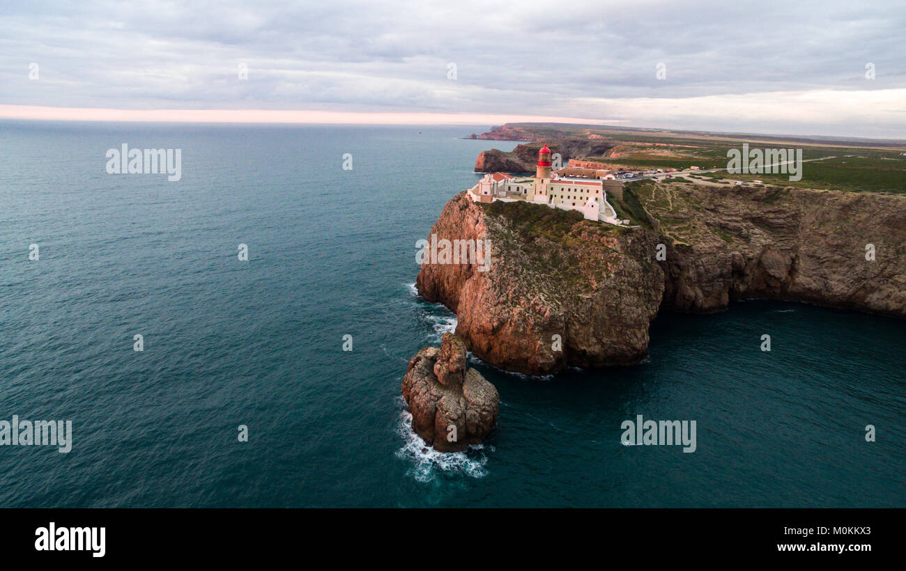 View of the lighthouse and cliffs at Cape St. Vincent at sunset ...