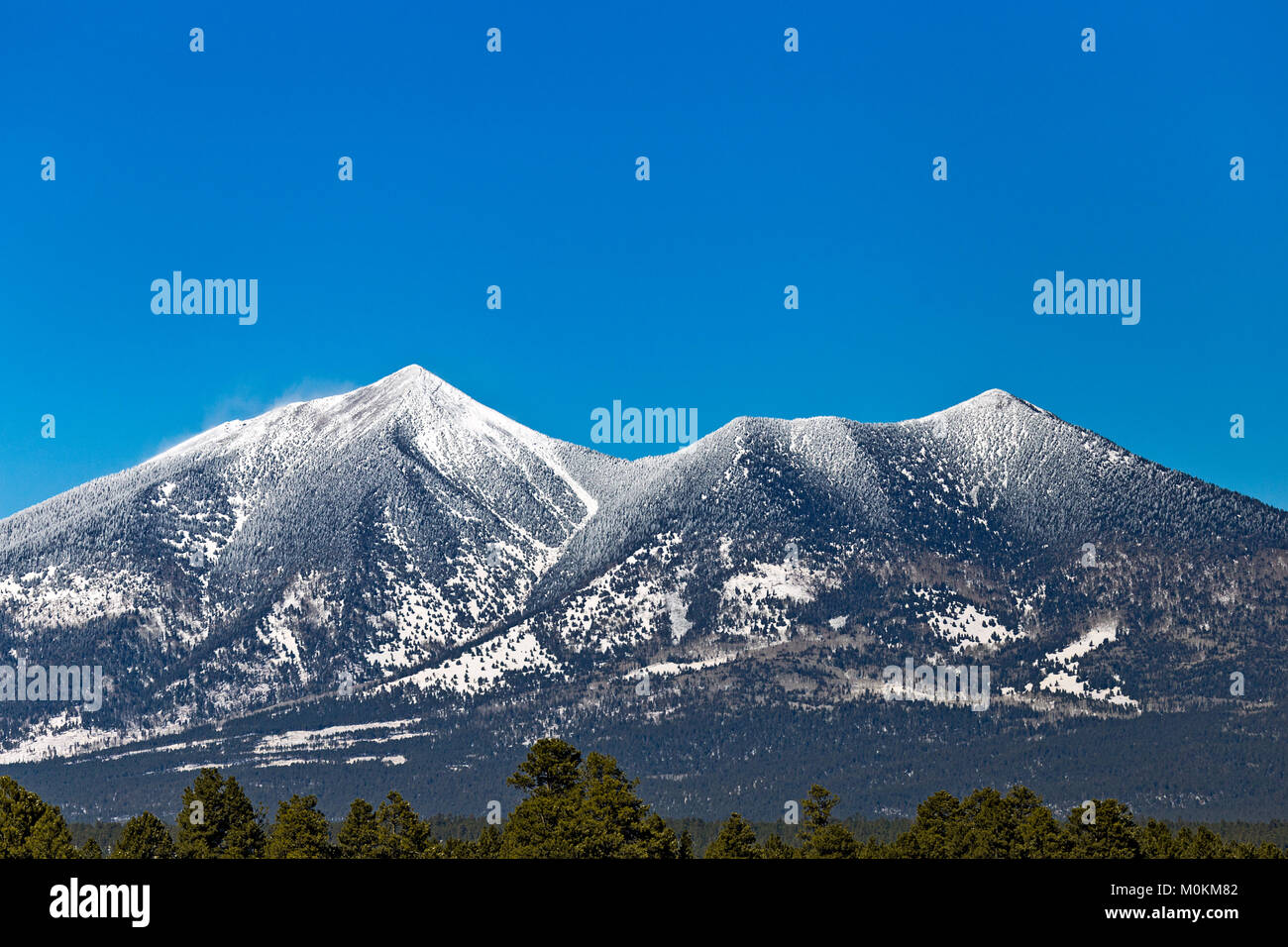 The San Francisco Peaks mountains with blue sky after a winter snow in Flagstaff, Arizona Stock Photo