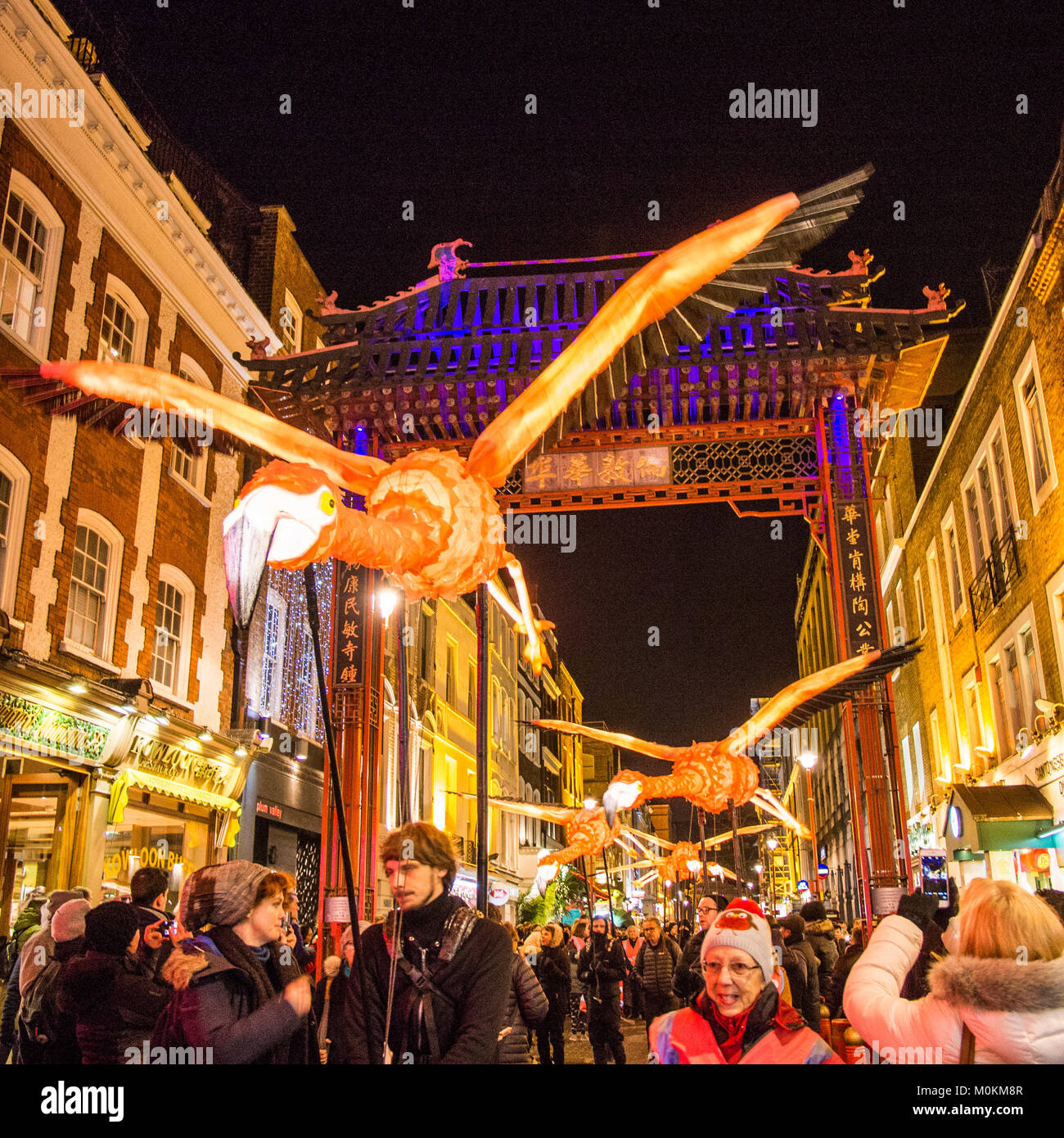 'Flying' Flamingo's operated by puppeteers in Chinatown during the 'Lumiere' Light Festival, London. Stock Photo