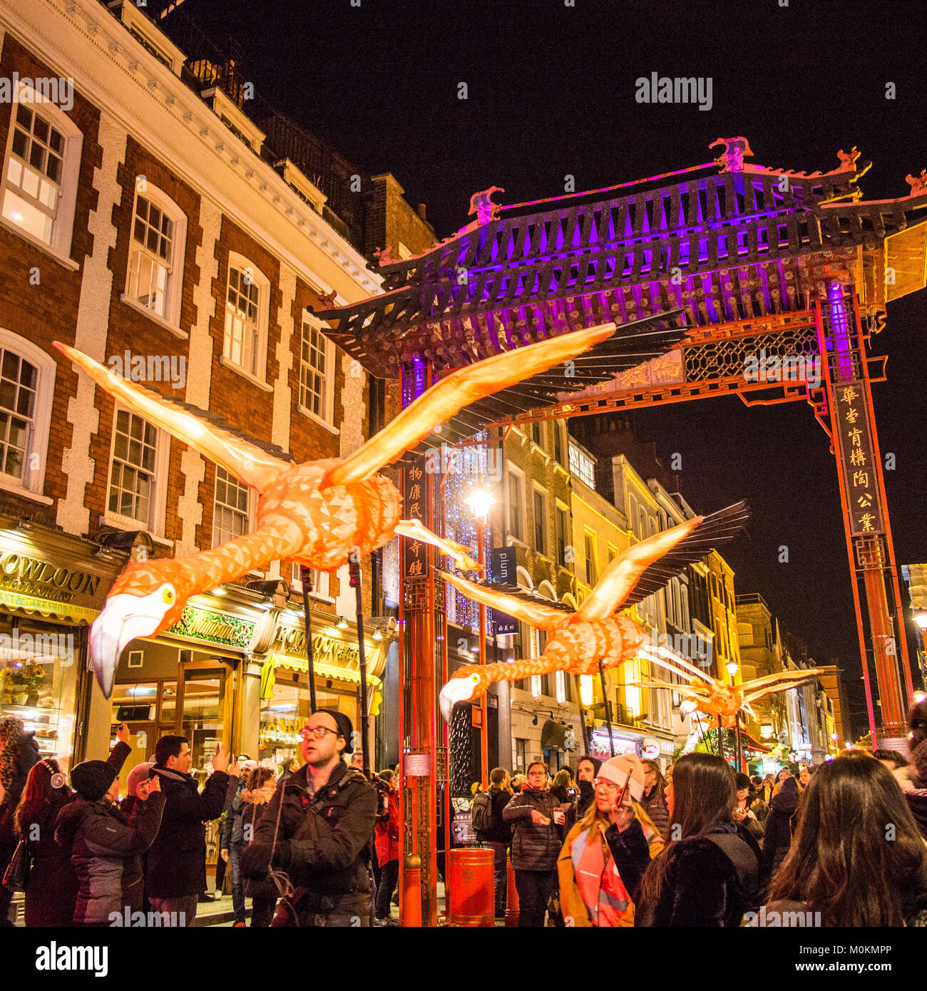 'Flying' Flamingo's operated by puppeteers in Chinatown during the 'Lumiere' Light Festival, London. Stock Photo