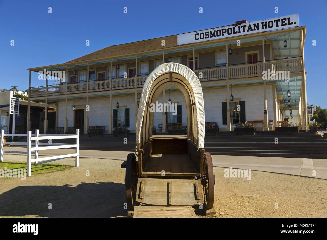 Historic Cosmopolitan Hotel and Restaurant framed by old west wagon wheel in San Diego Old Town State Park, opened after restoration in June 2010 Stock Photo