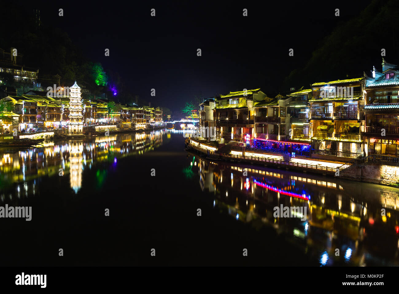 Night view of Fenghuang Ancient town, Hunan province, China. This ancient town was added to the UNESCO World Heritage Tentative List in the Cultural c Stock Photo